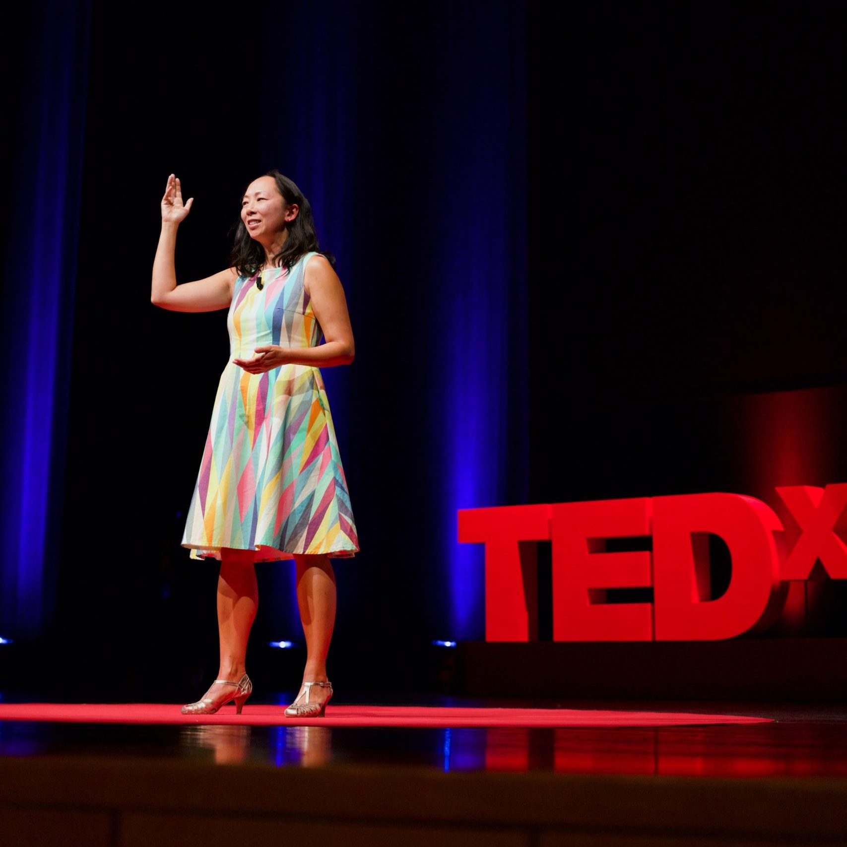 Grief Speaker - TEDxLisboa 2025 - Charlene Lam - DSC02717 speaking vertical hand up TEDx ©Eglė Duleckytė resized Hands with file label with "Grief" misspelled as "Greif"